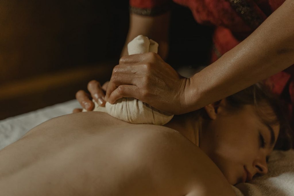 Woman enjoying a massage at an ayurvedic spa resort in Wayanad